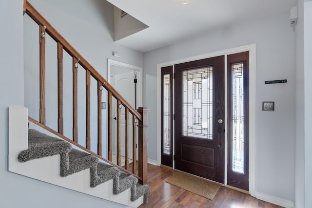 foyer entrance with wood-type flooring and a wealth of natural light