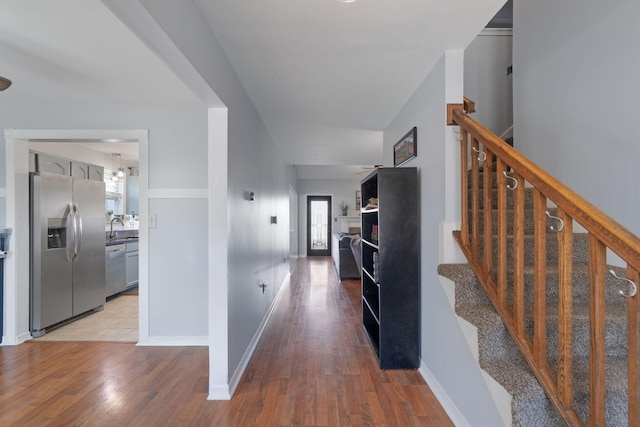 hallway with sink and light hardwood / wood-style floors