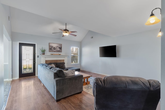 living room with ceiling fan, dark hardwood / wood-style flooring, and high vaulted ceiling