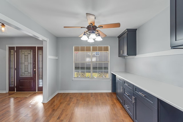 interior space with ceiling fan and wood-type flooring