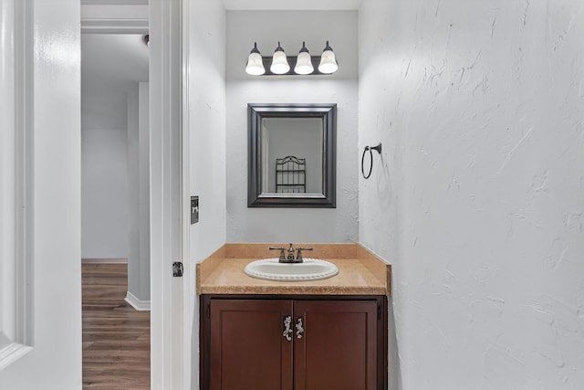 bathroom featuring wood-type flooring and vanity