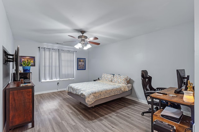 bedroom with ceiling fan and hardwood / wood-style flooring