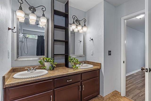 bathroom with a shower, wood-type flooring, and vanity