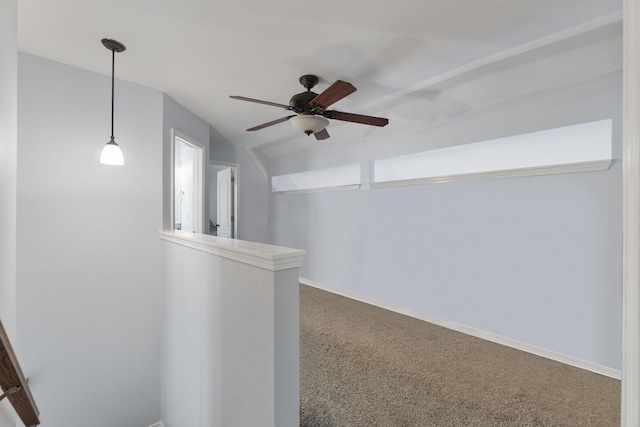 interior space featuring carpet, ceiling fan, and vaulted ceiling