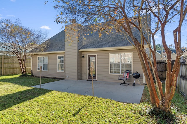 back of property featuring a lawn and a patio