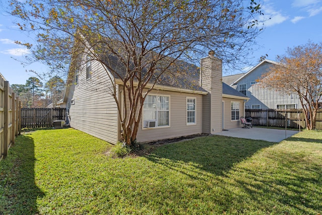 rear view of property featuring a lawn, a patio, and central AC unit