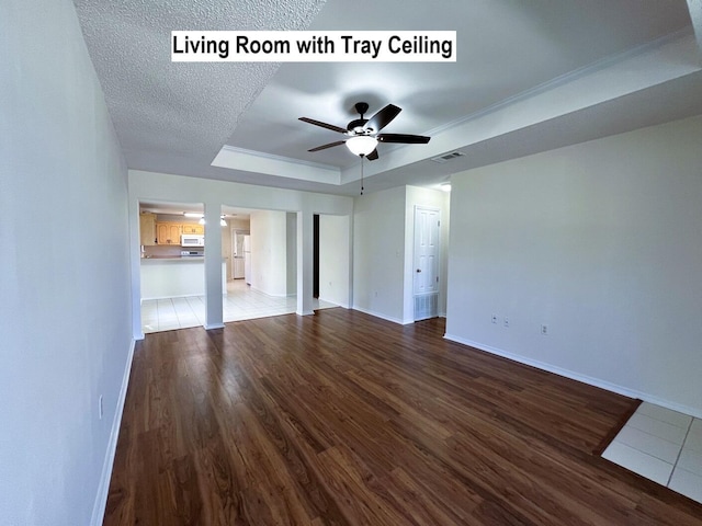 unfurnished living room with a raised ceiling, ceiling fan, a textured ceiling, and hardwood / wood-style flooring