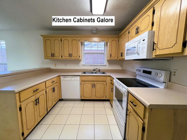 kitchen featuring a textured ceiling, light tile patterned flooring, white appliances, and sink