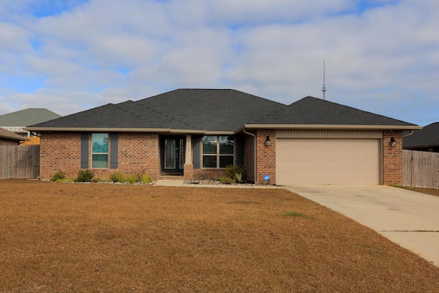 ranch-style house featuring a front lawn and a garage