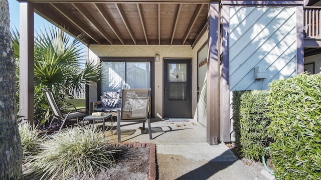 entrance to property featuring a patio