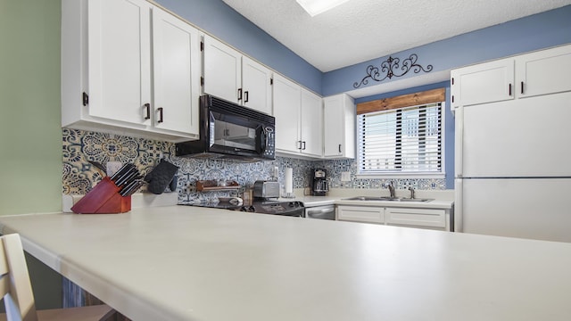 kitchen with decorative backsplash, a textured ceiling, sink, white cabinets, and white fridge