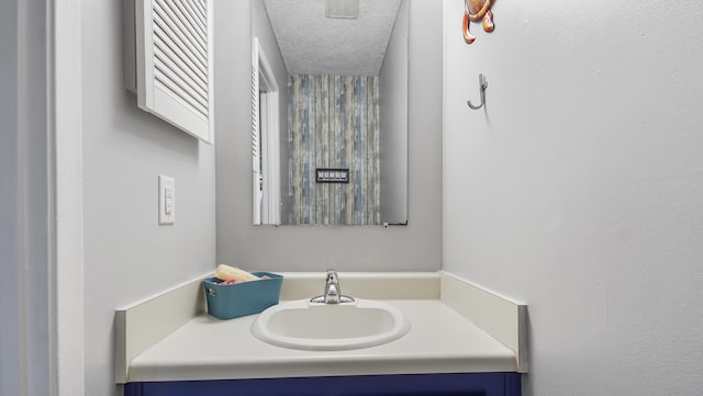 bathroom with a textured ceiling and vanity