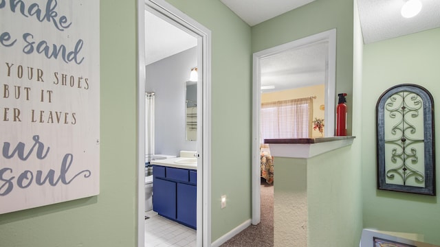 hallway with a textured ceiling