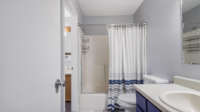 full bathroom with vanity, toilet, shower / bath combo with shower curtain, and a textured ceiling