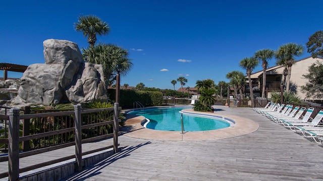 view of swimming pool with a patio area and a deck