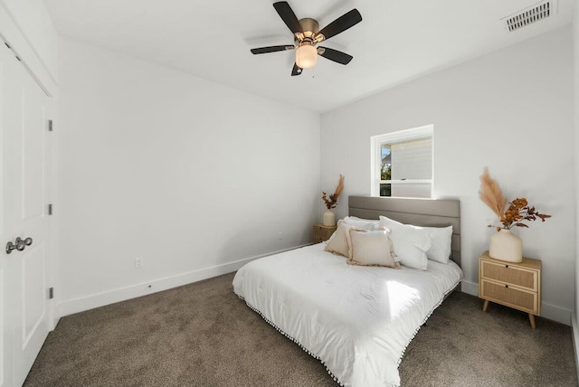 bedroom featuring ceiling fan and dark carpet