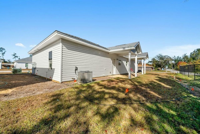 view of property exterior featuring a lawn and central air condition unit