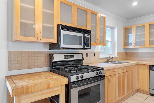 kitchen featuring appliances with stainless steel finishes, backsplash, ornamental molding, sink, and light tile patterned floors