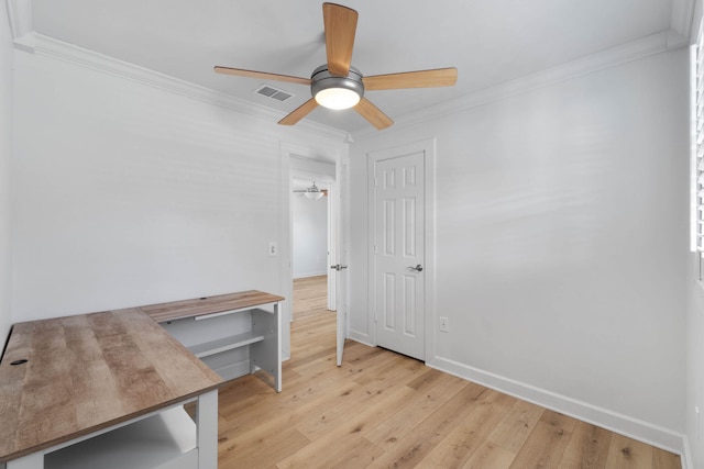 interior space featuring ceiling fan, ornamental molding, and light wood-type flooring