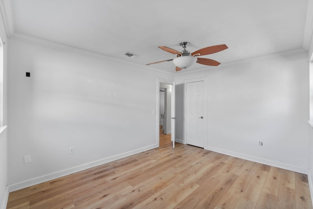 empty room with ceiling fan, light hardwood / wood-style floors, and ornamental molding