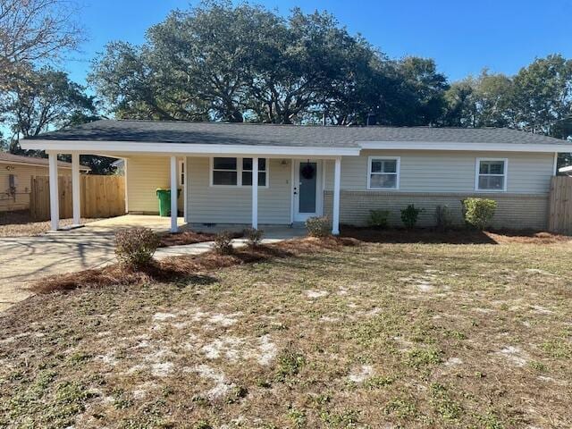 single story home with a carport and a front lawn