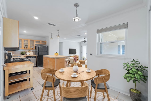 dining room with light tile patterned floors, ceiling fan, and crown molding