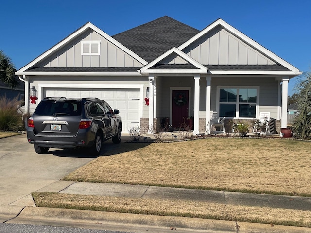 craftsman house featuring a porch, a front yard, and a garage