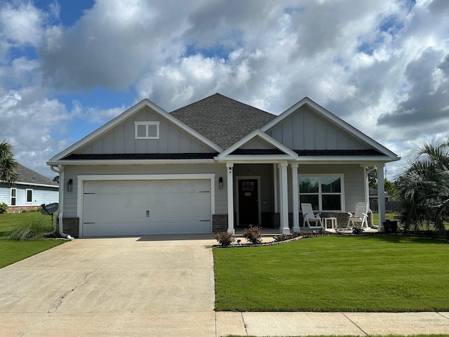 238 Partridge Ln, Freeport, FL 32439 - craftsman-style home featuring concrete driveway, a front yard, board and batten siding, and covered porch
