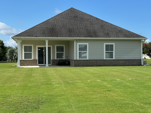 238 Partridge Ln, Freeport, FL 32439 - rear view of house with roof with shingles, a lawn, and brick siding