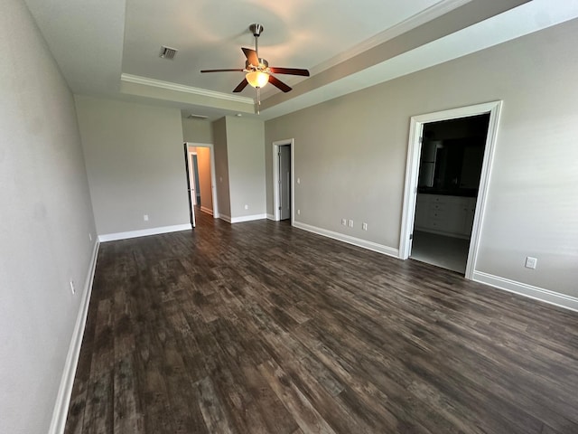 238 Partridge Ln, Freeport, FL 32439 - unfurnished bedroom featuring a raised ceiling, dark wood-type flooring, crown molding, and ensuite bath