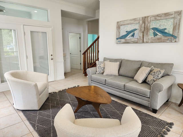 living room featuring crown molding and light tile patterned flooring