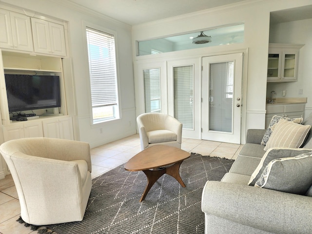 tiled living room with sink and crown molding