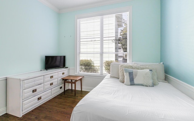 bedroom with crown molding and dark hardwood / wood-style floors