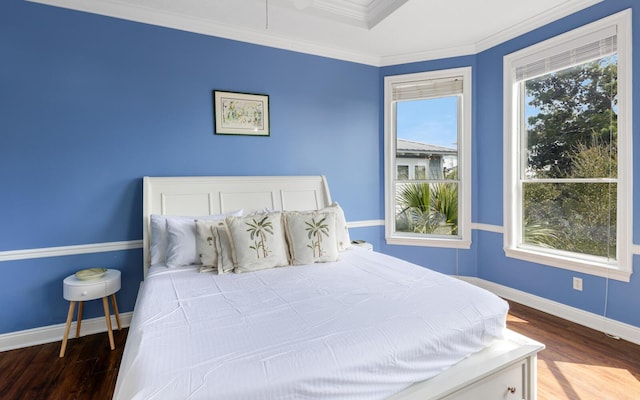 bedroom with crown molding and hardwood / wood-style floors