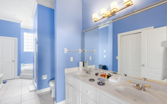 bathroom with a tub, vanity, ornamental molding, toilet, and tile patterned floors