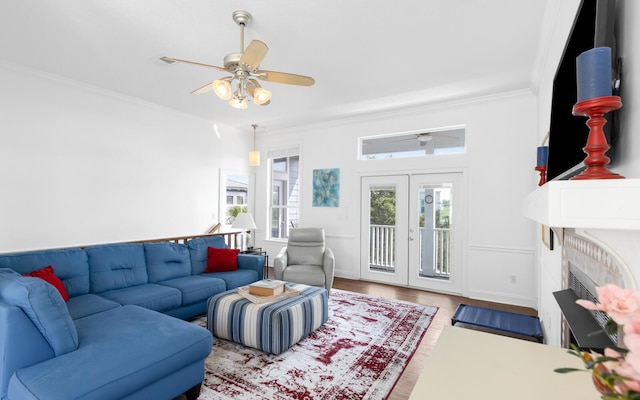 living room with french doors, ceiling fan, ornamental molding, and light hardwood / wood-style flooring