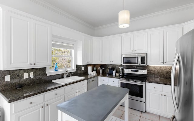 kitchen featuring white cabinetry, sink, stainless steel appliances, and a center island