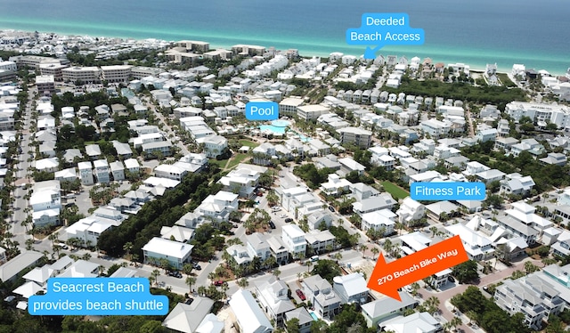 birds eye view of property featuring a water view and a beach view