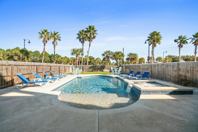 view of pool featuring an in ground hot tub and a patio