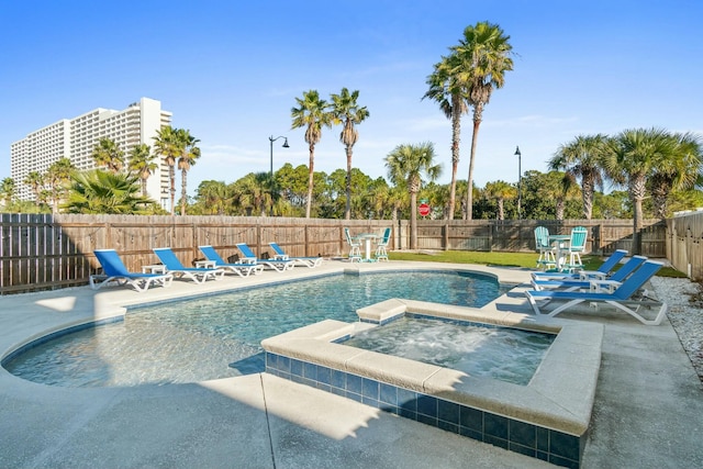 view of pool with an in ground hot tub and a patio