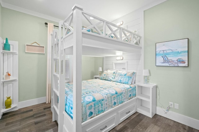 bedroom with dark hardwood / wood-style flooring and ornamental molding