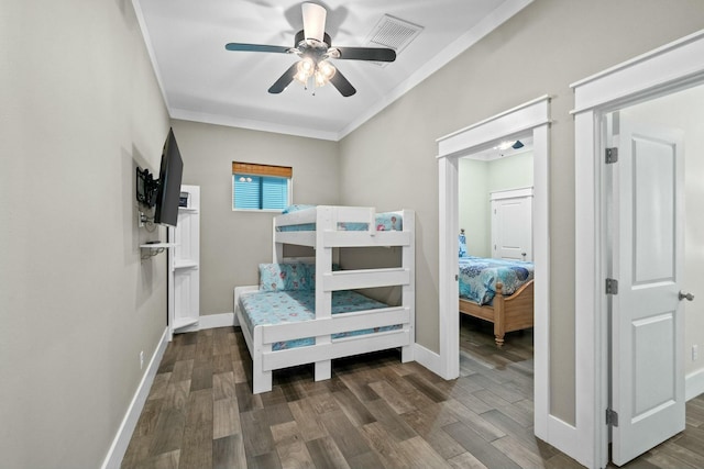 bedroom with ceiling fan, dark hardwood / wood-style flooring, and crown molding