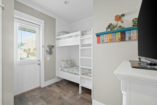 bedroom featuring wood-type flooring and ornamental molding