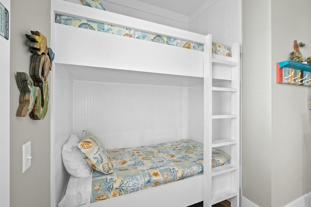 bedroom featuring wooden walls