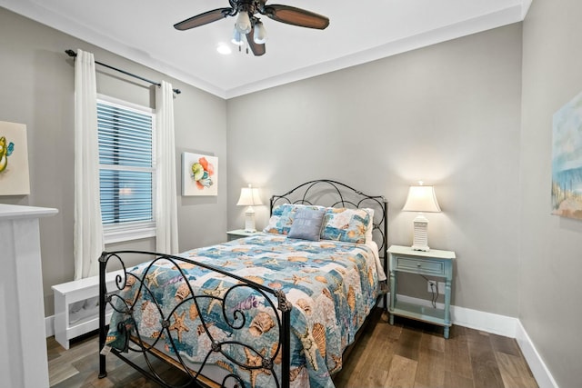 bedroom with ceiling fan and dark wood-type flooring