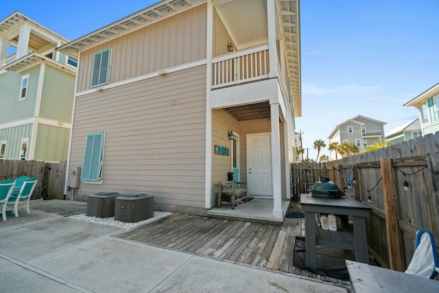 back of property featuring a patio, central AC, and a deck