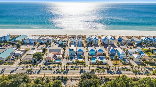 drone / aerial view featuring a view of the beach and a water view