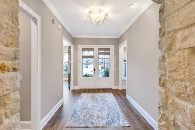 foyer entrance with dark hardwood / wood-style flooring, crown molding, and french doors