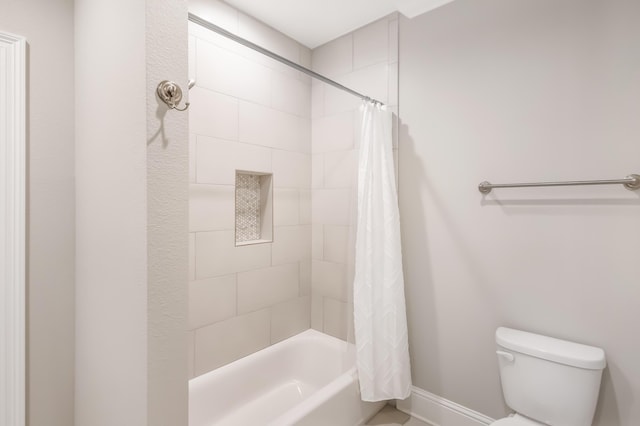 bathroom with shower / bath combo and toilet