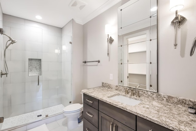 bathroom featuring tile patterned floors, ornamental molding, vanity, toilet, and a shower with shower door